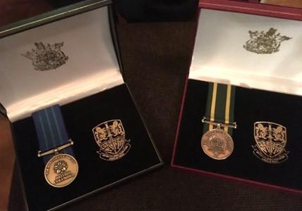 Photo of a Medal of Meritorious Service and a Medal of Valorous Service in display boxes